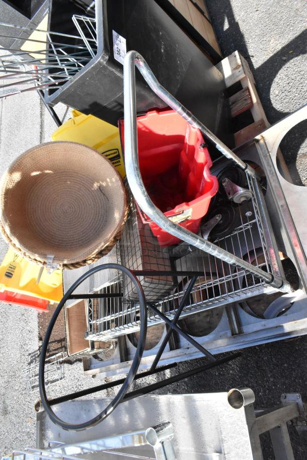 Pallet lot with assorted items including trash cans, metal cart, red plastic bucket, and woven basket. Visible item tag labeled "302".
