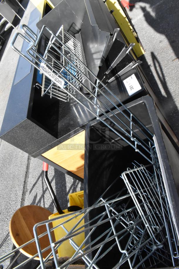 Pallet lot containing assorted items including trash cans and cart. Includes metal racks labeled "Made in China." Mixed condition.