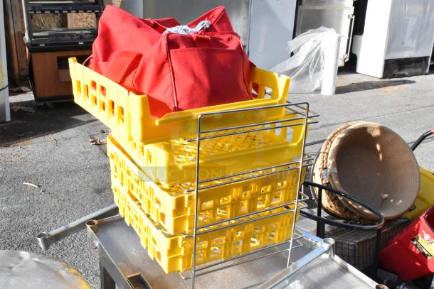 Metal table on commercial casters with stacked yellow crates and red bag on top. Baskets and miscellaneous items included.