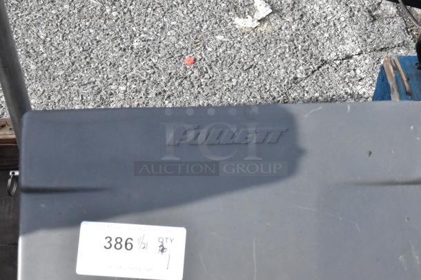 Follett Ice Bin Cart with embossed logo, visible auction tag, gray metal, outdoor setting. Signs of use, good condition.
