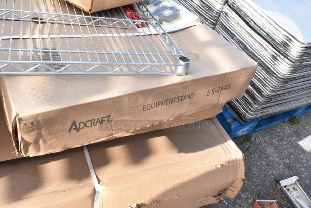 9 new scratch and dent items, including Cambro shelving, Adcraft ES-2448 stand, Centaur shelf. Boxes visible with labels.