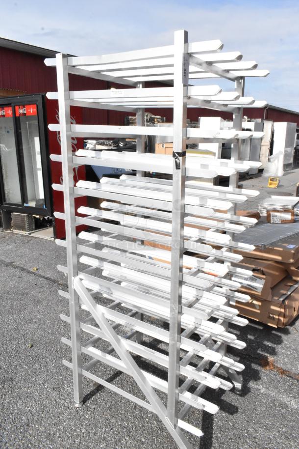 Stainless steel #10 can rack with multiple shelves, excellent condition, ideal for organized storage.