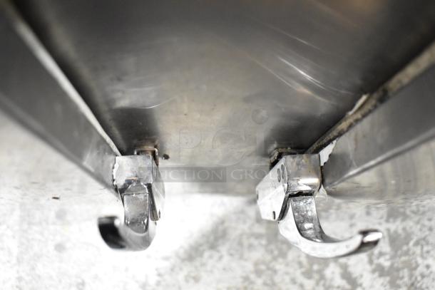 Close-up of the latch mechanism on a Leader LB84 Stainless Steel Commercial 3 Door Undercounter Cooler.