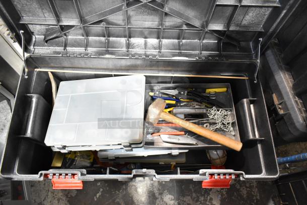 Black tool box with assorted tools including a hammer, pliers, and a plastic organizer. In good condition.