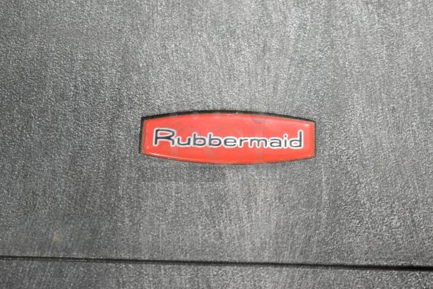 Rubbermaid tool box with contents, featuring a durable black plastic exterior and brand logo. Good condition.
