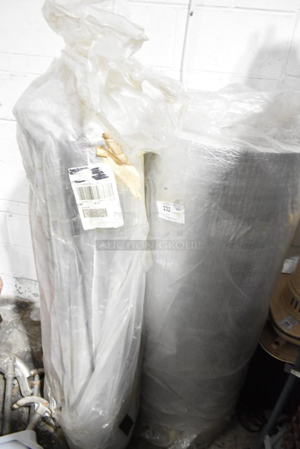 Three items including large insulated rolls wrapped in plastic with visible labels and barcodes, and a wet floor sign.