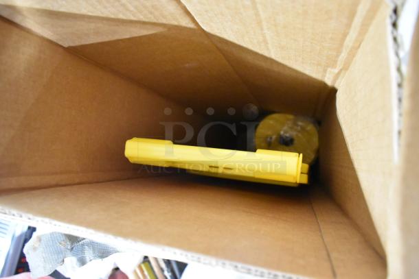 Cardboard box containing yellow wet floor sign and insulated rolls, visible condition, auction lot with three items.