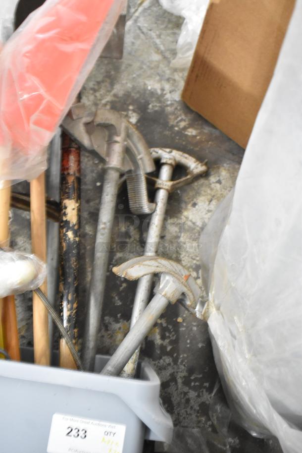 Gray Slim Jim trash can containing various tools including a rake, broom, and shovel. Condition shows wear. Lot of 20.