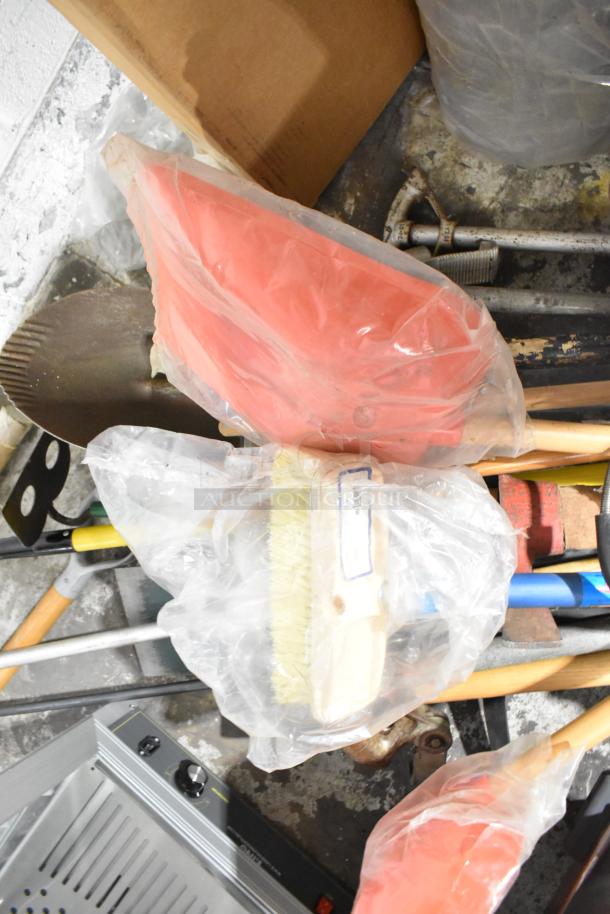 Gray Slim Jim trash can containing 20 mixed items, including a red shovel, rake, and broom, wrapped in plastic bags, ideal for multipurpose use.