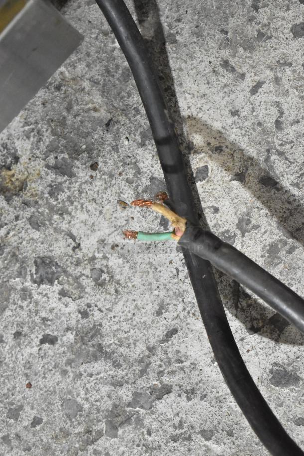 Damaged power cord of a Hobart D-300T planetary dough mixer. Exposed wires may need repair for safe operation.