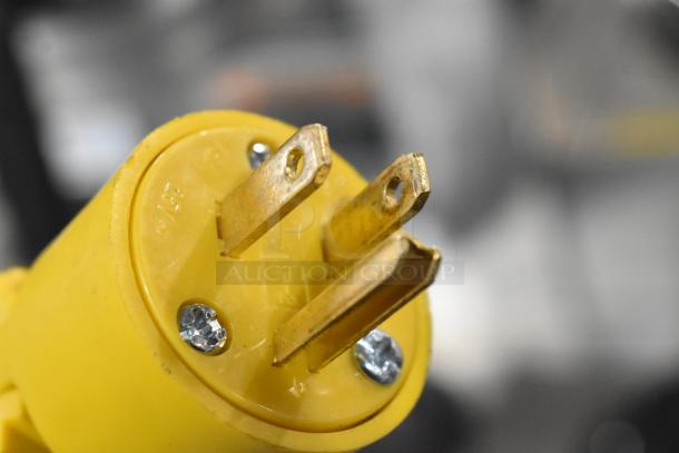 Close-up of a yellow electrical plug for the Bunn CRTF5-35 coffee machine, showing three prongs and two screws.