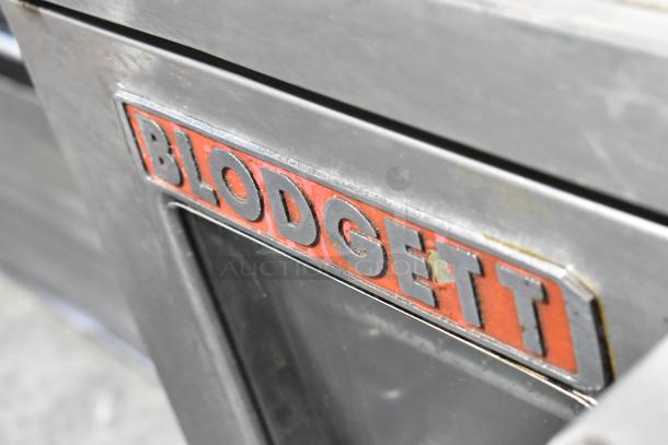 Blodgett stainless steel commercial convection oven, features view-through doors, metal oven racks, thermostatic controls.