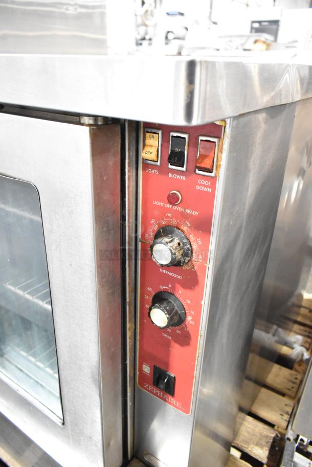 Blodgett stainless steel convection oven with glass doors, metal racks, and thermostatic controls; model Zephaire visible.