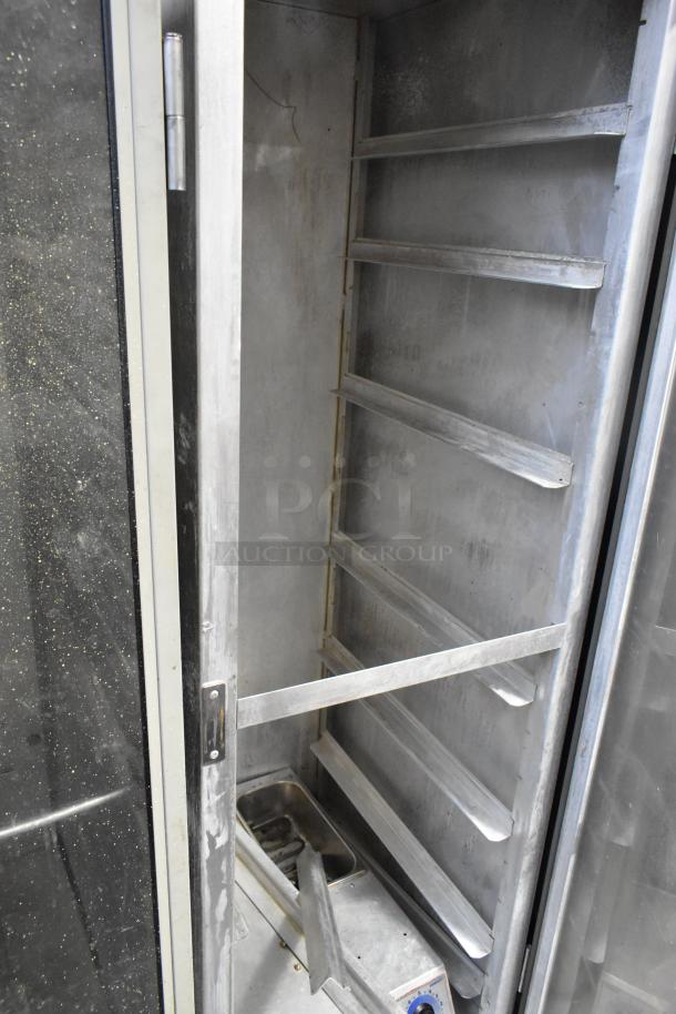 Lockwood Metal Commercial Heated Holding Cabinet with shelves, used condition, on commercial casters, features temperature controls.