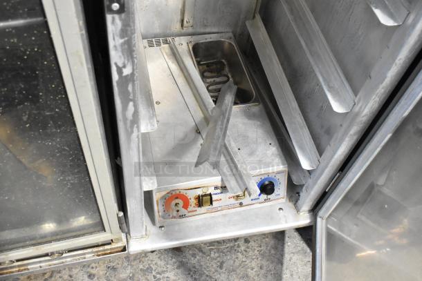 Lockwood metal commercial heated holding cabinet with temperature controls and commercial casters, in used condition.