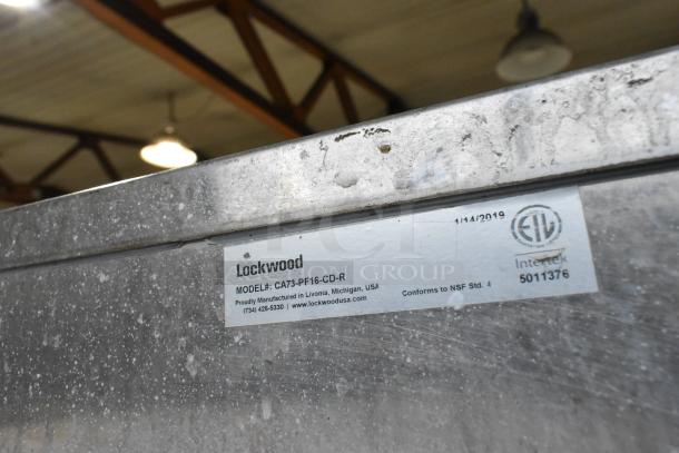 Lockwood metal heated holding cabinet on casters. Model: CA73-PF16-CD-R. Conforms to NSF Std. 4. Manufactured in 2019.