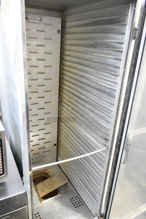 Omcan metal heated holding cabinet, interior view. Features commercial casters, stainless steel, good condition.