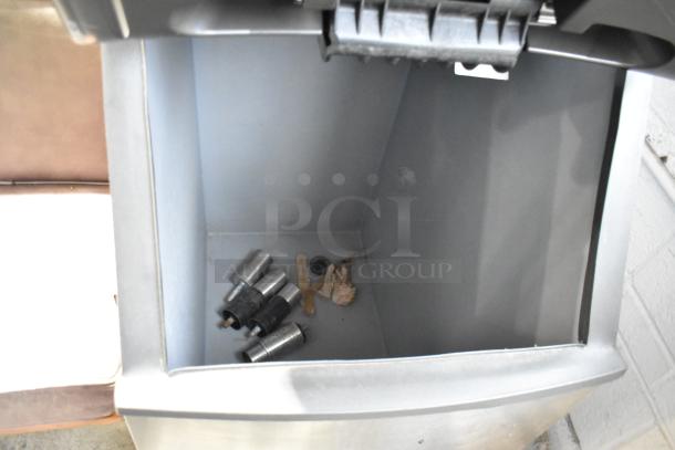 Manitowoc IRT0620A-161 stainless steel commercial ice head on bin, 115 volts, 1 phase, minor debris visible inside.