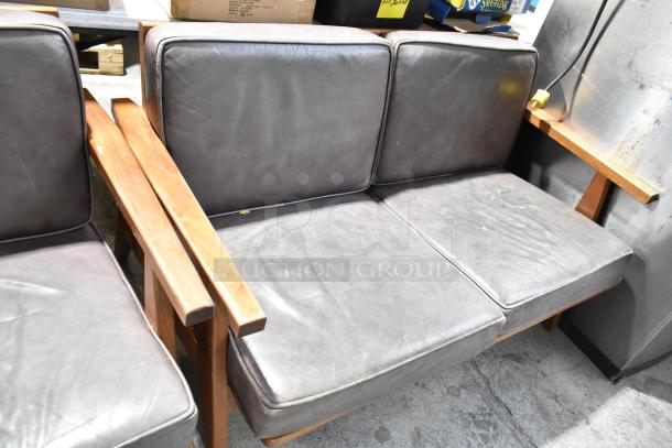 Two wooden seats with gray cushions; includes a chair and two-person couch. Visible wear, sturdy frame, vintage appeal.