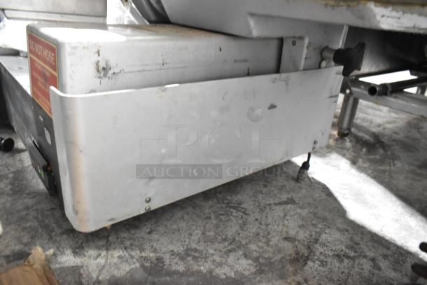 Bizerba metal commercial countertop meat slicer stacker, in used condition, with visible wear marks and "Do Not Hose" label.