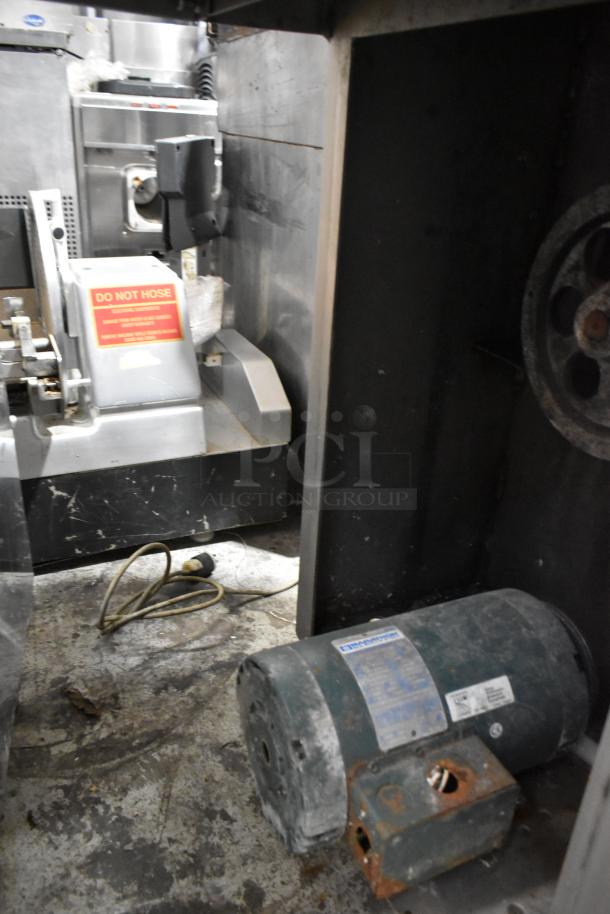 Metal commercial floor-style meat saw, used condition, features visible motor and power cord. "DO NOT HOSE" label attached.