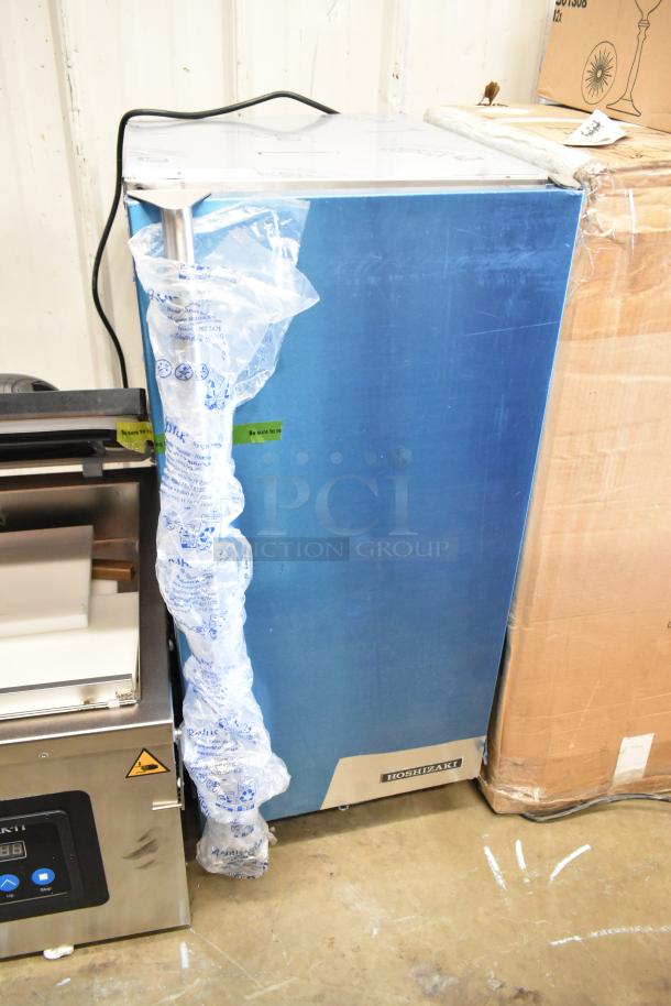 Brand new Hoshizaki AM-50BAK stainless steel ice machine. Scratch and dent condition, blue wrapping, Hoshizaki logo visible.
