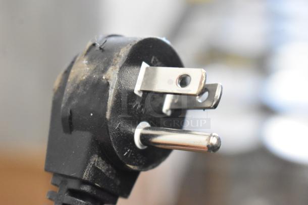 Close-up of a power plug with visible dust and wear, part of a Hoshizaki AM-50BAK ice machine.