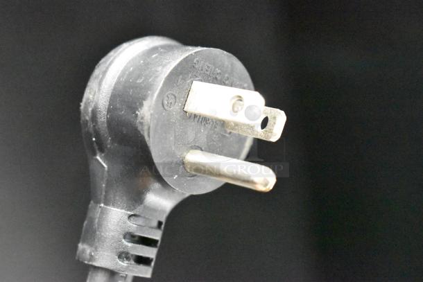 ALT Text: 
Close-up of a power plug for the True GDM-23-HC cooler, showing standard prongs, suitable for 115 volts, 1 phase.