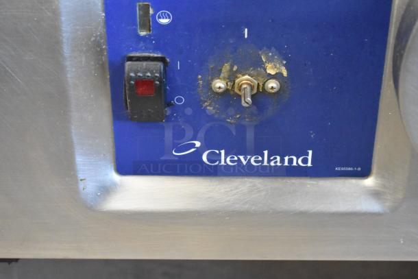Cleveland stainless steel commercial braising pan control panel with visible wear, featuring a power switch and Cleveland branding.