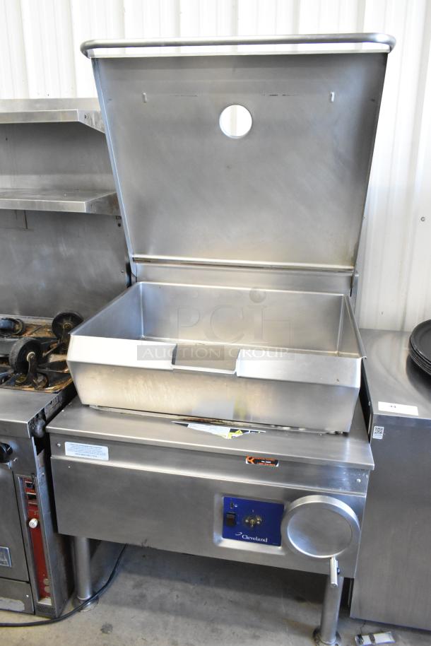 Cleveland stainless steel commercial braising pan, floor style, used, with adjustable lid and control panel. Brand label visible.
