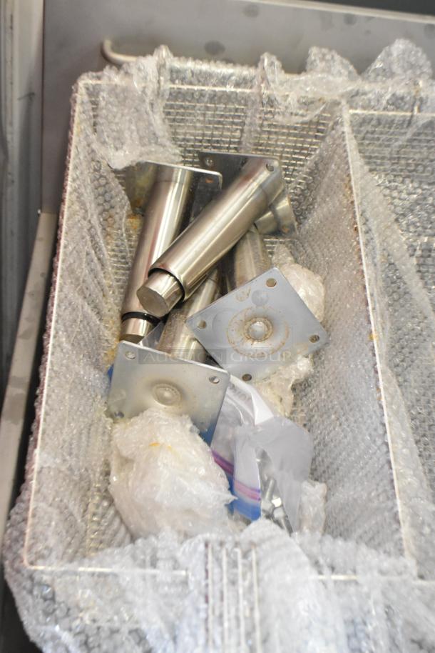 Stainless steel parts with bubble wrap in Avantco fryer basket, model 177FFES70L, indicating a scratch and dent condition.