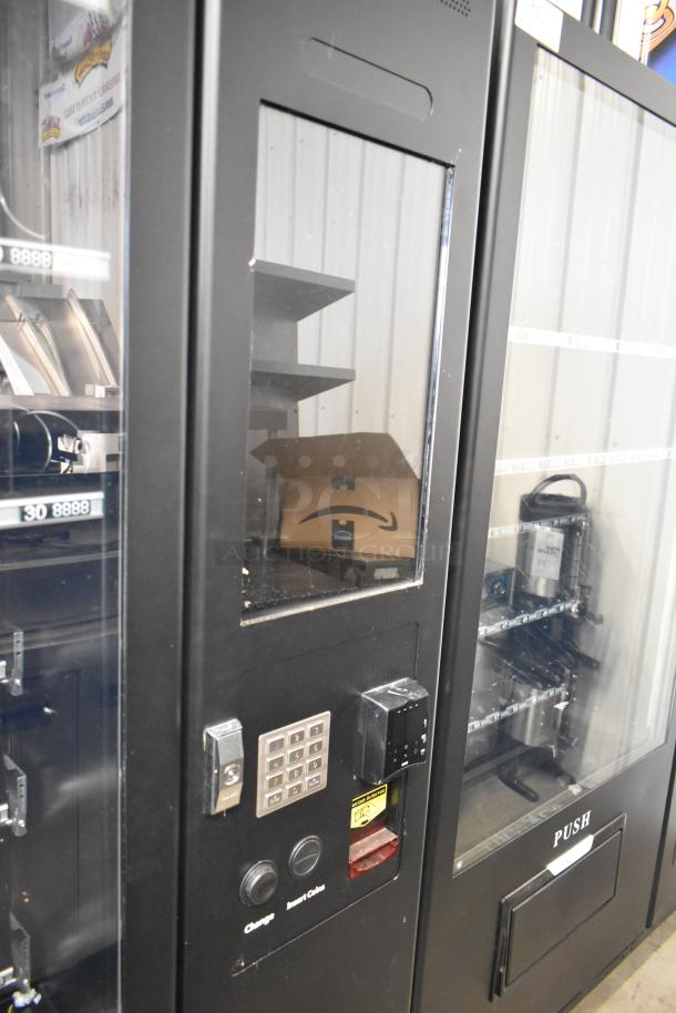 Brand new KoolMore metal commercial vending machine, black with keypad and coin insert, scratch and dent condition.