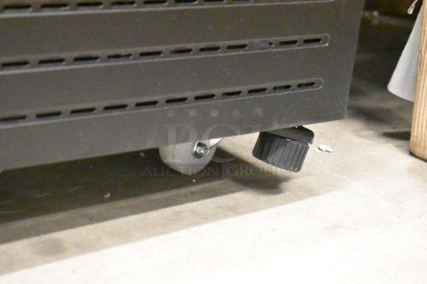 KoolMore KM-MDR-1GD-10C metal cooler base showing commercial caster wheels and black leveling foot; new condition.