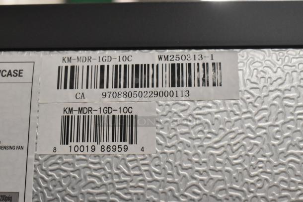 Barcodes and model labels on KoolMore KM-MDR-1GD-10C cooler, highlighting serial number and model details.