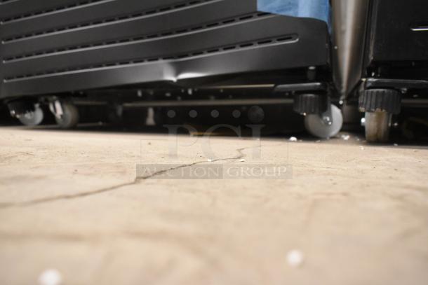 KoolMore KM-MDR-1GD-10C cooler on commercial casters, showing underside and wheels; new with scratch and dent condition.