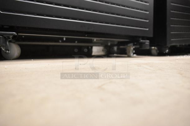 BRAND NEW KoolMore KM-MDR-1GD-10C cooler with poly-coated racks on commercial casters, showing base detail.