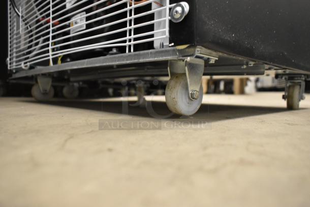 KoolMore KM-MDR-1GD-10C reach-in cooler base, showing commercial caster wheels and metal frame.