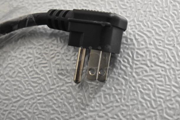 Close-up of power cord for KoolMore KM-MDR-1GD-10C cooler, showing a 115-volt plug with a textured background.