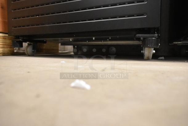 KoolMore KM-MDR-1GD-10C reach-in cooler base on commercial casters. Metal construction, 115 Volts, 1 Phase. Scratch and dent condition.