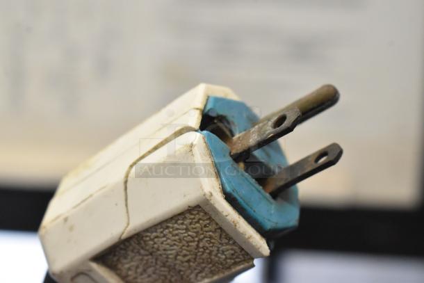 Close-up of the power plug for a Manitowoc  IY0524A-161D ice machine, showing wear and discoloration.