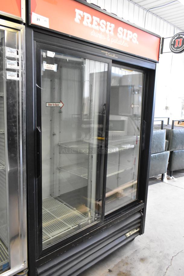 True GDM-45 metal 2-door reach-in cooler merchandiser with poly-coated racks, commercial casters, and branding label visible.