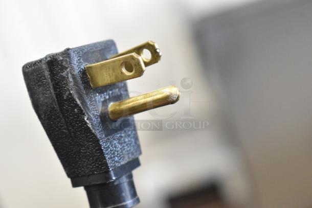 Close-up of a power plug for the True GDM-45 commercial cooler, showing a three-prong plug design.