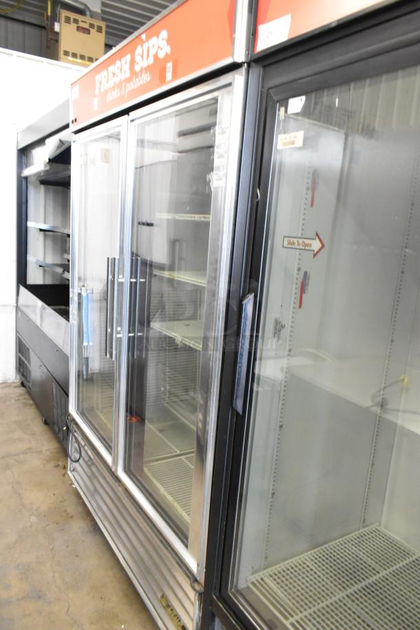 True GDM-49 commercial 2-door cooler merchandiser with poly-coated racks, on casters. Good condition, 115 volts, 1 phase.