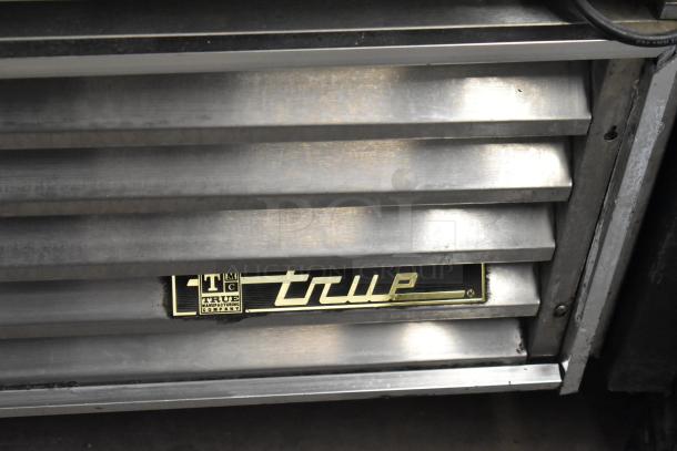 True GDM-49 commercial cooler label, metal construction, 115 volts, poly-coated racks, on commercial casters.