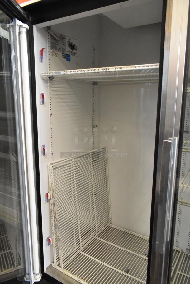 True GDM-49 metal commercial 2-door reach-in cooler with poly-coated racks, on casters, 115V, 1 phase, clean interior.