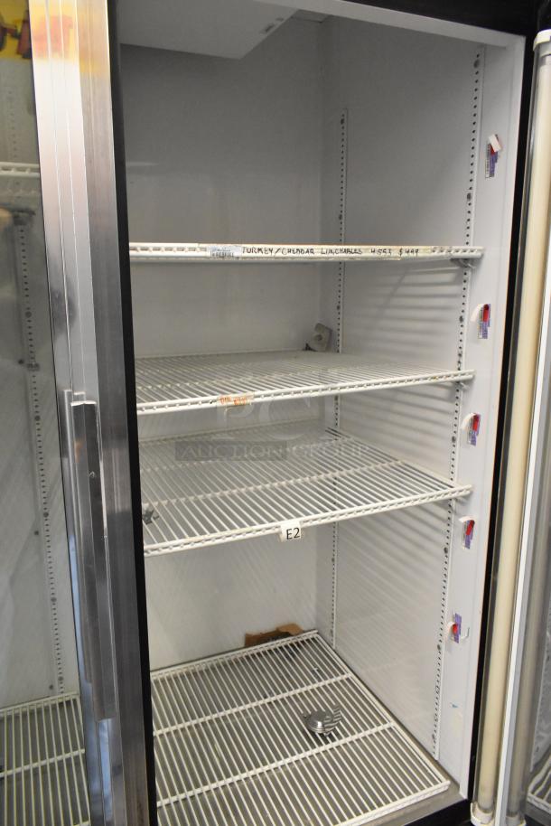 True GDM-49 2-door reach-in cooler, poly-coated racks, on commercial casters, 115 volts, 1 phase, has labels on shelves.