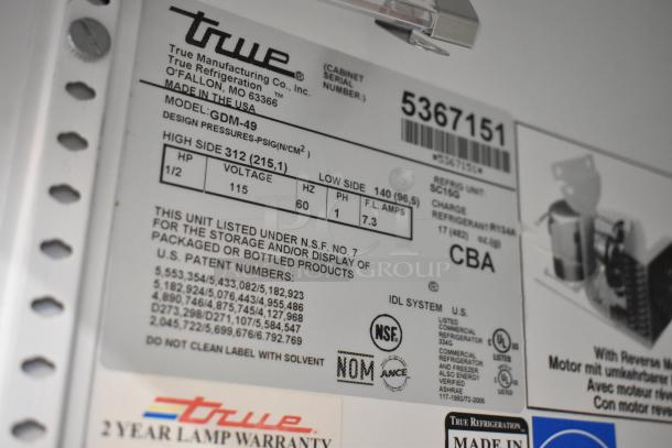 True GDM-49 metal commercial cooler label, 115V, 1 phase. Features model, voltage, and NSF certification for packaged products.