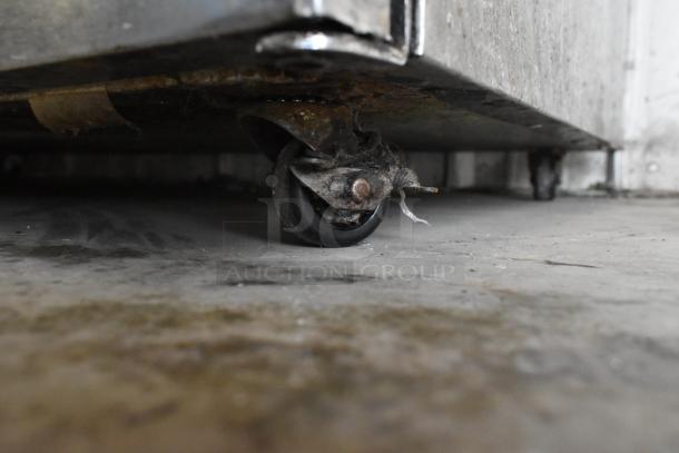 Delfield UC4048-STAR cooler on caster with visible wear and rust. Stainless steel, 115V, 1-phase. Commercial use.