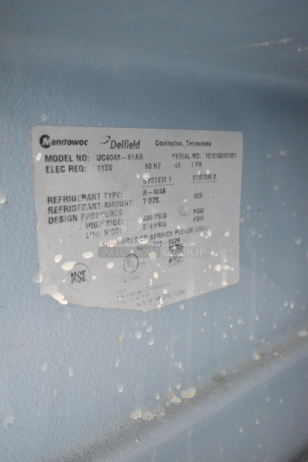Delfield UC4048-STAR cooler label indicating 115V, R-404A refrigerant, commercial use. Model and serial numbers visible.