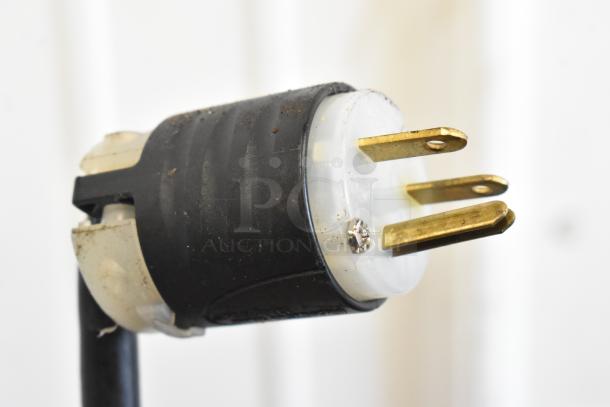 Power plug for Hatco TQ-800HBA Toast Qwik Toaster Oven, showing three prongs and black plastic casing. Dust present.